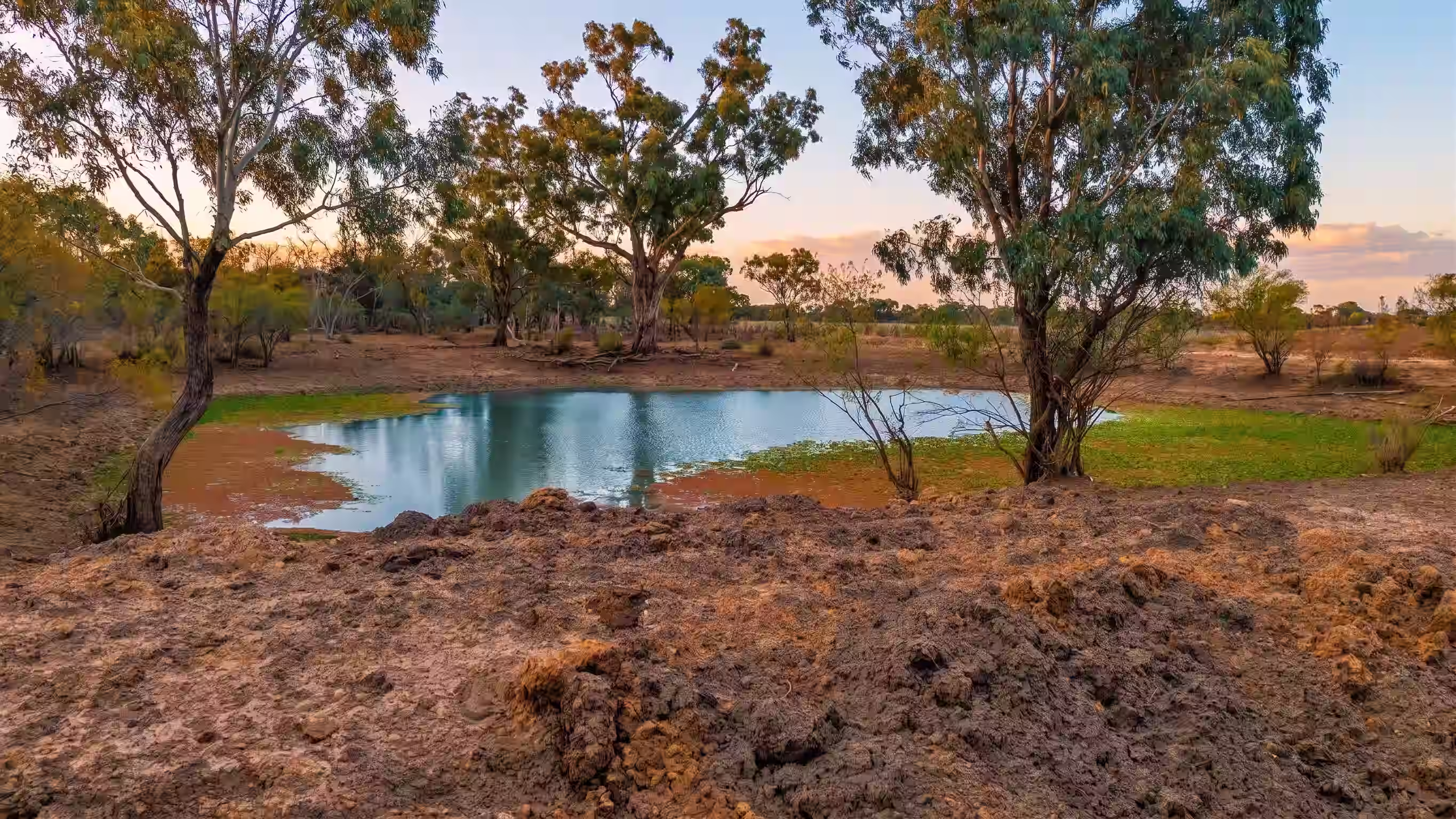 Sunset over an earthen stock dam at Ryans Ridge near Mungindi