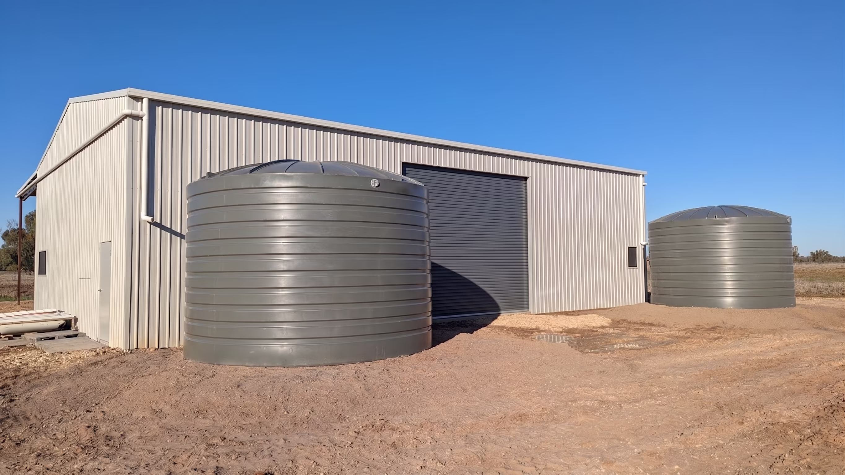 Machinery shed with large rainwater storage harvesting tanks